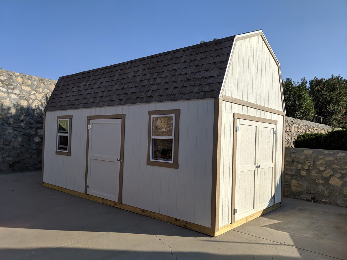 A beige custom shed in an El Paso backyard.