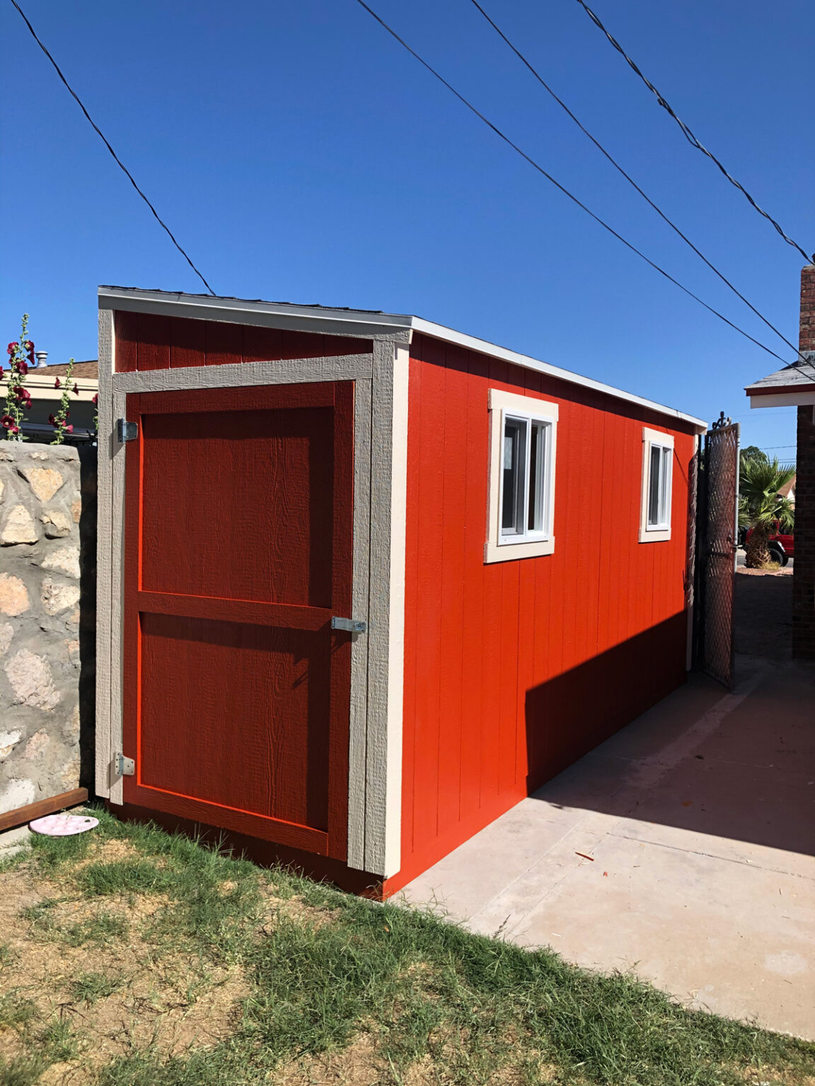 A red lean-to shed in an El Paso yard.