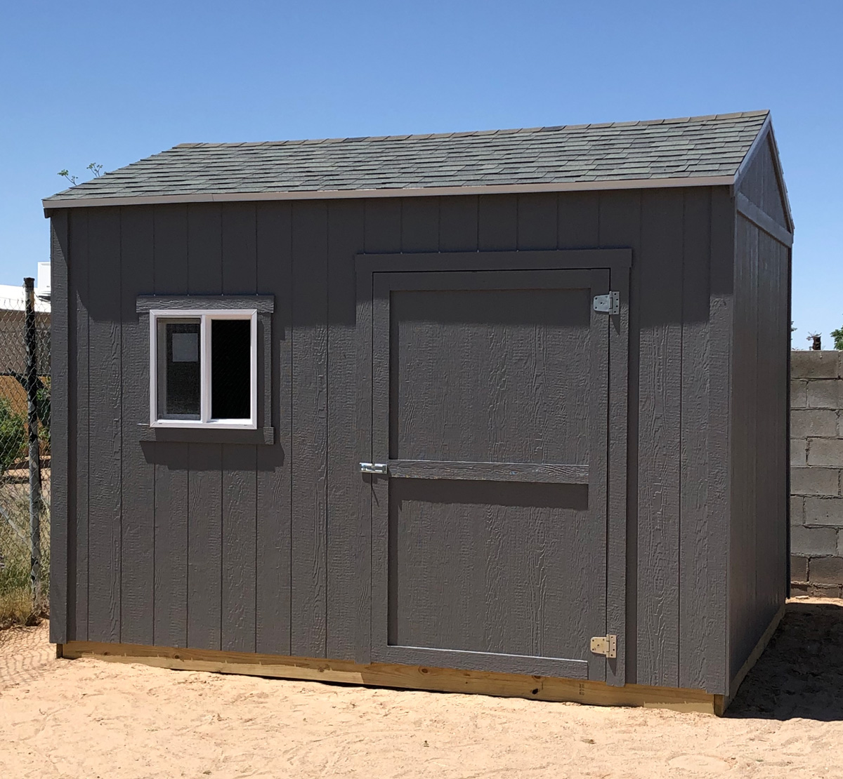 A dark grey outdoor storage shed in El Paso.